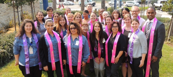 Image of a group of MemorialCare Long Beach Medical Center employees wearing pink and purple to help educate the community about breast and gynecologic cancers.