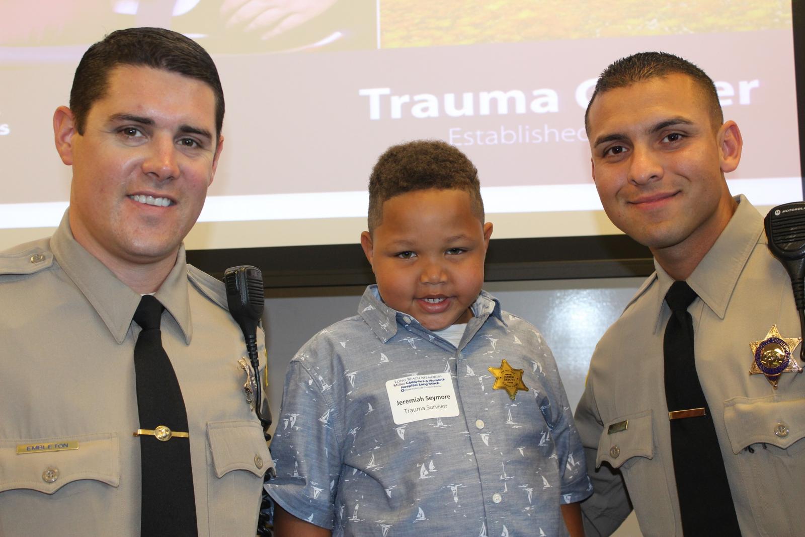 Image from Trauma Survivors Day reunion and of Jeremiah Seymour and the two LA County Sheriff deputies that helped him after he was mauled by a dog. 