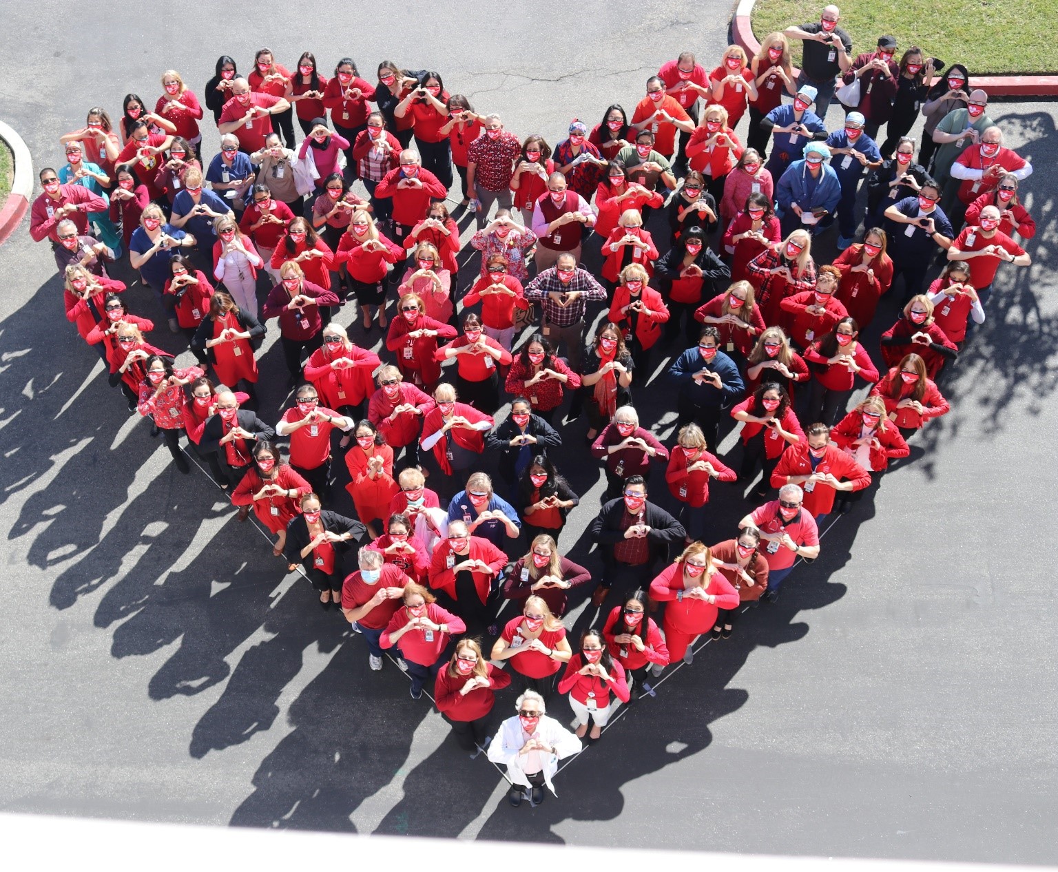 MemorialCare Saddleback Medical Center employees create a giant human heart to raise awareness of heart disease in women on National Wear Red Day.