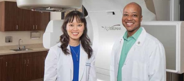 Image of two medical staff in front of TrueBeam™ and VitalBeam™ advanced cancer medical linear accelerators. These technologies are available at MemorialCare Saddleback Medical Center. 