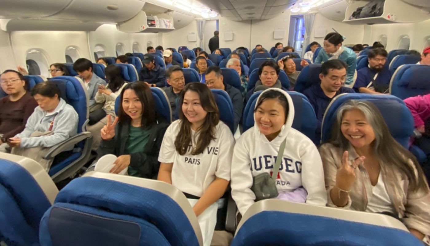 People sitting on a packed international flight